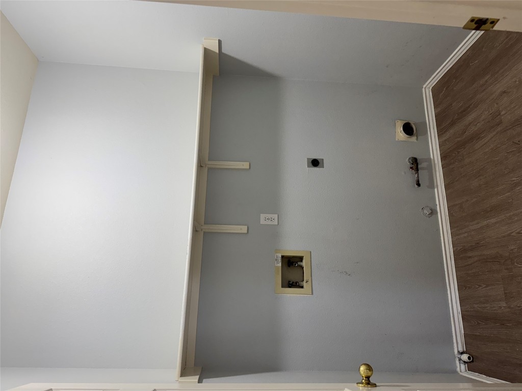 12714 Tantara Drive Austin, TX 78729 - Photo 16 of 25 Laundry room with gas dryer hookup, washer hookup, dark wood-type flooring, and electric dryer hookup