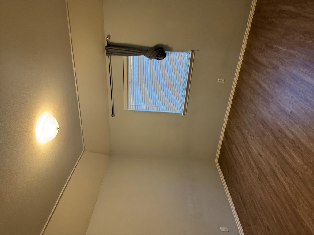12714 Tantara Drive Austin, TX 78729 - Photo 20 of 25 Spare room featuring dark wood-type flooring and vaulted ceiling