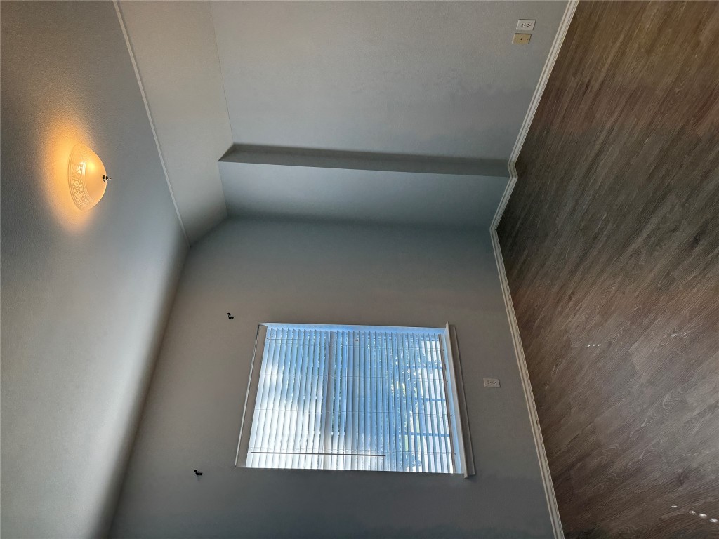 12714 Tantara Drive Austin, TX 78729 - Photo 21 of 25 Spare room featuring dark wood-type flooring and vaulted ceiling