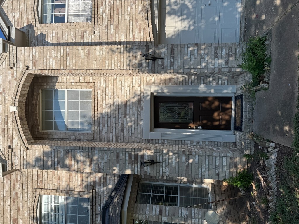 12714 Tantara Drive Austin, TX 78729 - Photo 4 of 25 Doorway to property featuring brick siding