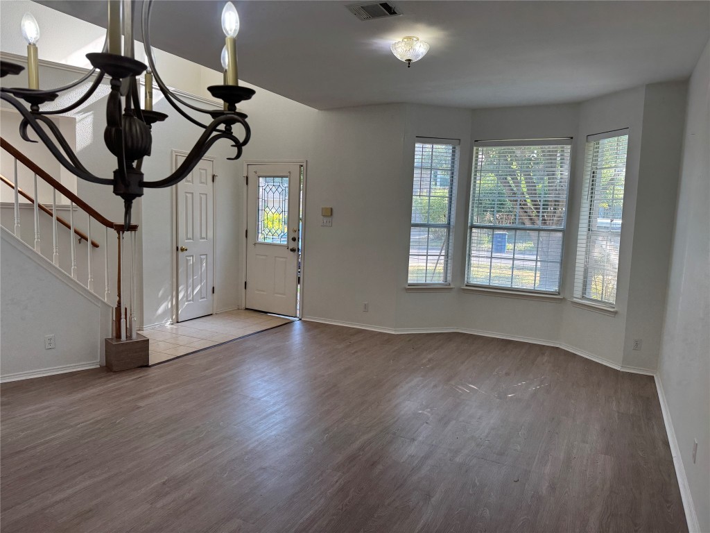 12714 Tantara Drive Austin, TX 78729 - Photo 6 of 25 Foyer with wood finished floors, stairway, and a chandelier