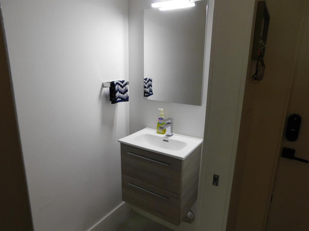 4381 Northwest 9th Street, Unit 4381 Plantation, FL 33317 - Photo 13 of 46 a bathroom with a sink and a mirror