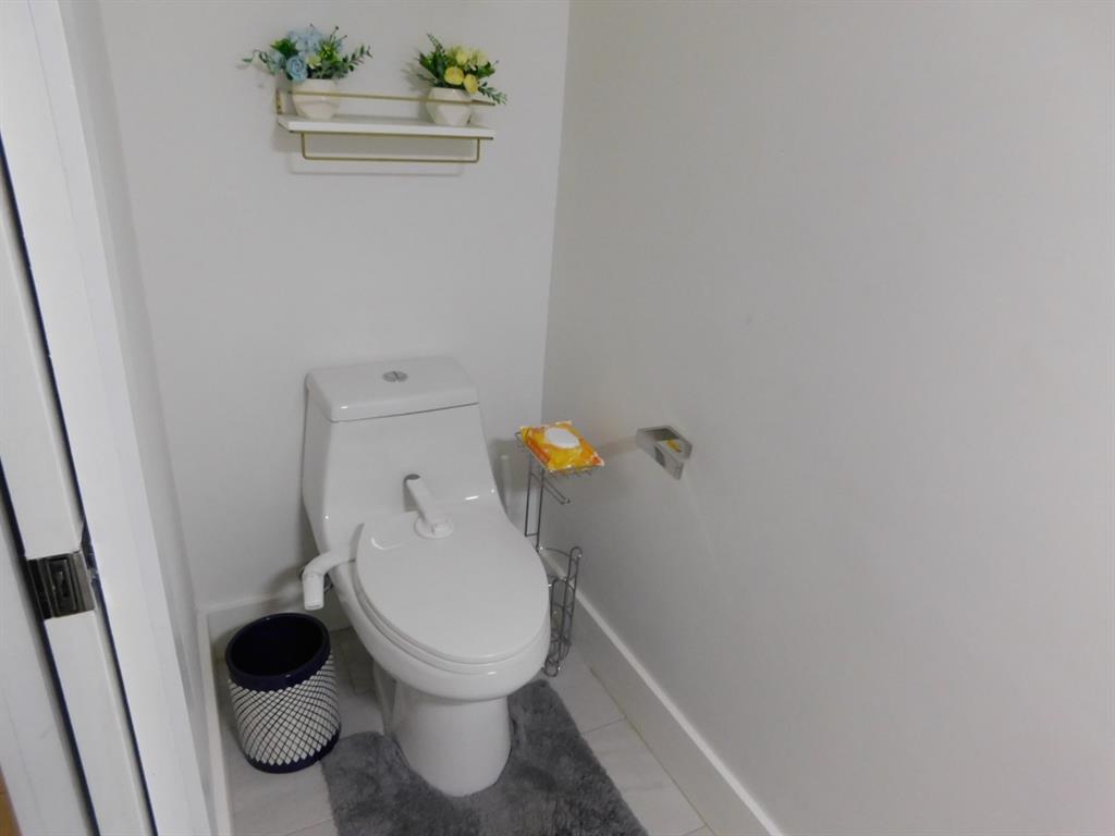 4381 Northwest 9th Street, Unit 4381 Plantation, FL 33317 - Photo 15 of 46 a white toilet sitting next to a sink