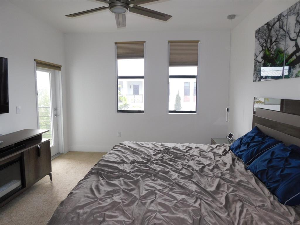 4381 Northwest 9th Street, Unit 4381 Plantation, FL 33317 - Photo 16 of 46 a bedroom with a bed and a window