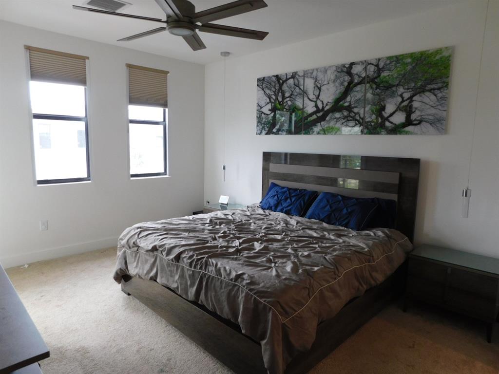 4381 Northwest 9th Street, Unit 4381 Plantation, FL 33317 - Photo 17 of 46 a bed sitting in a bedroom next to a window