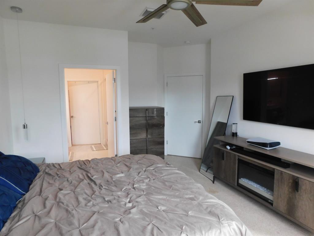 4381 Northwest 9th Street, Unit 4381 Plantation, FL 33317 - Photo 19 of 46 a bedroom with a bed and a flat screen tv