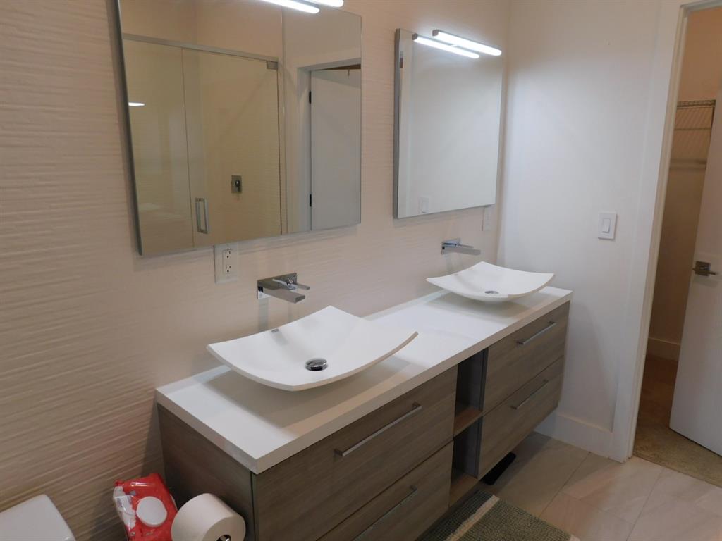 4381 Northwest 9th Street, Unit 4381 Plantation, FL 33317 - Photo 24 of 46 a bathroom with a sink vanity and a mirror