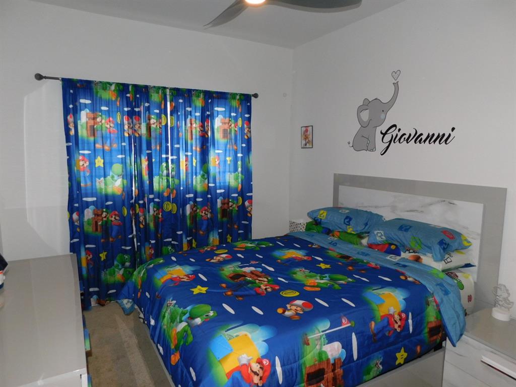 4381 Northwest 9th Street, Unit 4381 Plantation, FL 33317 - Photo 27 of 46 a bedroom with a bed that has a blanket on it and next to a window