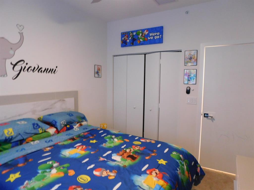 4381 Northwest 9th Street, Unit 4381 Plantation, FL 33317 - Photo 28 of 46 a bedroom with a bed and a dresser in it