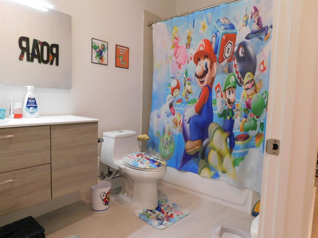 4381 Northwest 9th Street, Unit 4381 Plantation, FL 33317 - Photo 30 of 46 a bathroom with a sink mirror and toilet