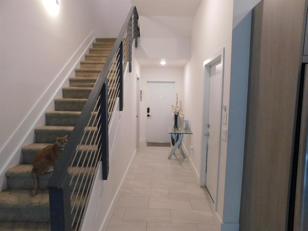 4381 Northwest 9th Street, Unit 4381 Plantation, FL 33317 - Photo 3 of 46 a view of a hallway with stairs and a couch