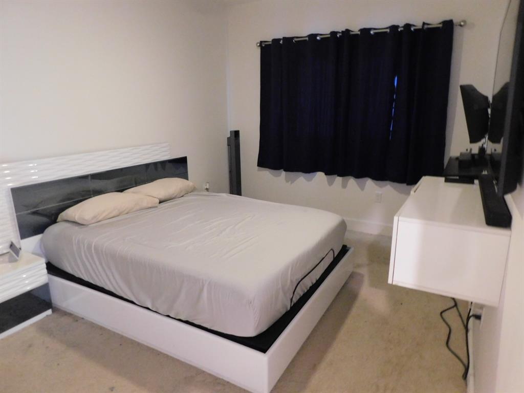 4381 Northwest 9th Street, Unit 4381 Plantation, FL 33317 - Photo 31 of 46 a bedroom with a bed and a dresser