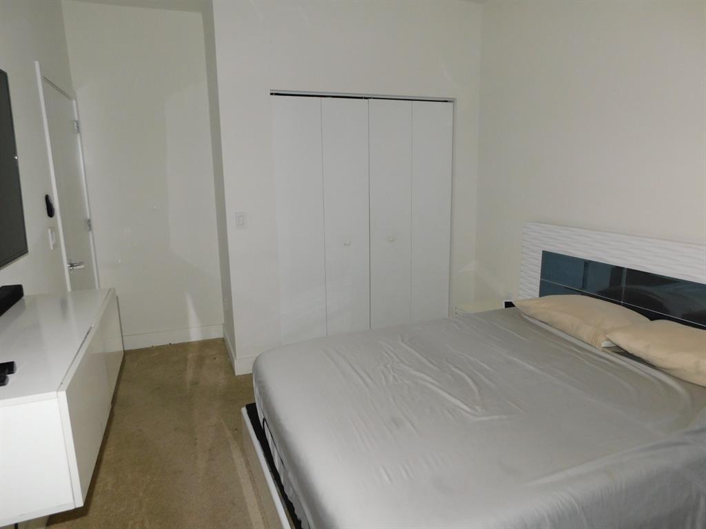 4381 Northwest 9th Street, Unit 4381 Plantation, FL 33317 - Photo 33 of 46 a bedroom with a bed and a flat screen tv