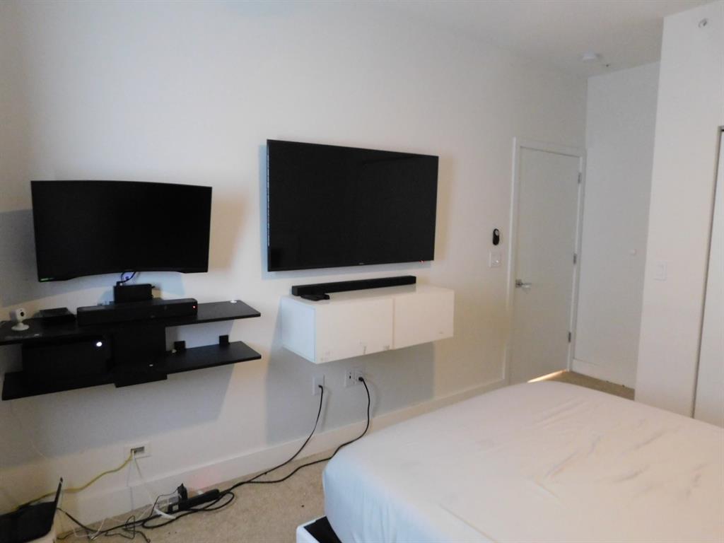 4381 Northwest 9th Street, Unit 4381 Plantation, FL 33317 - Photo 34 of 46 a bedroom with a bed and a flat screen tv