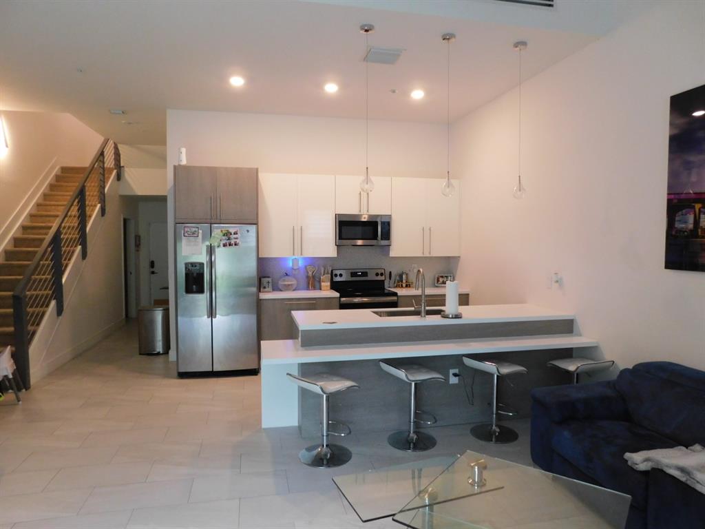 4381 Northwest 9th Street, Unit 4381 Plantation, FL 33317 - Photo 4 of 46 a kitchen with a sink appliances and cabinets