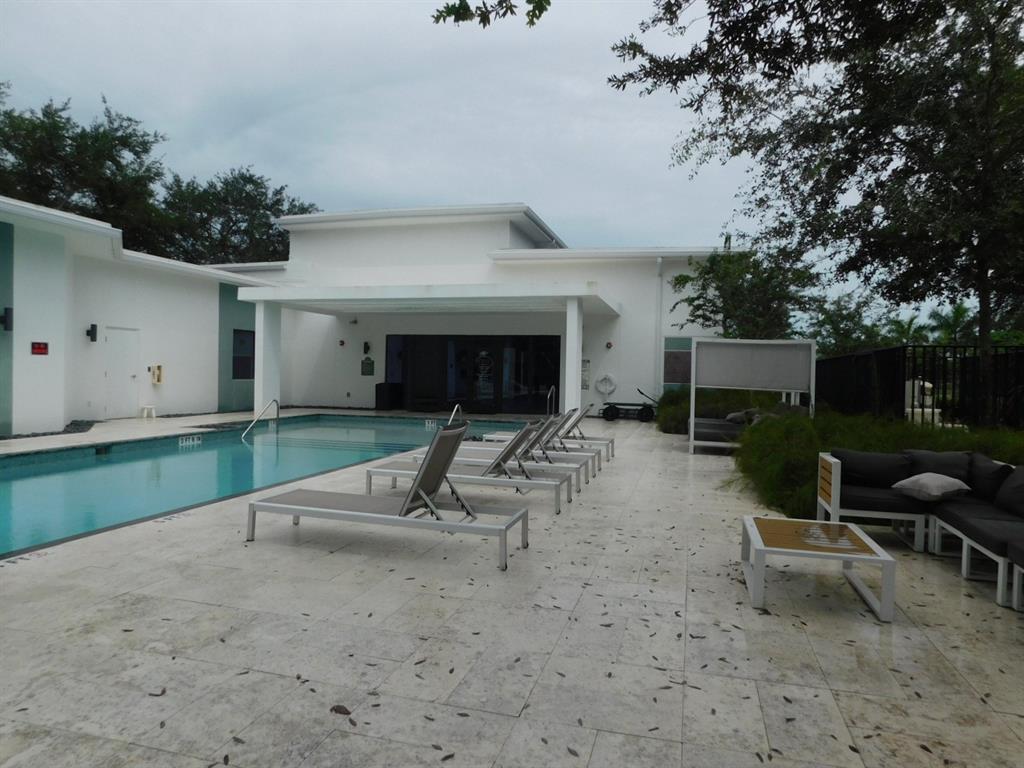 4381 Northwest 9th Street, Unit 4381 Plantation, FL 33317 - Photo 44 of 46 a view of a house with backyard and sitting area
