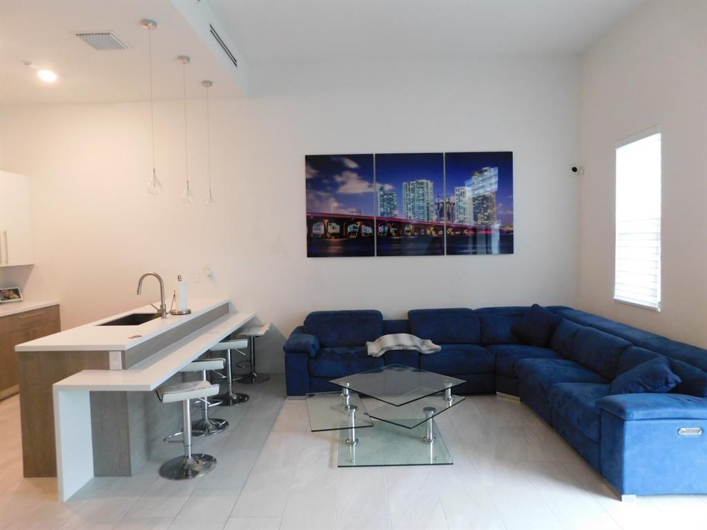 4381 Northwest 9th Street, Unit 4381 Plantation, FL 33317 - Photo 6 of 46 a living room with furniture and a window