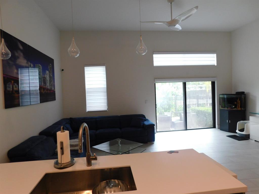 4381 Northwest 9th Street, Unit 4381 Plantation, FL 33317 - Photo 7 of 46 a kitchen with a sink a counter top space and a window
