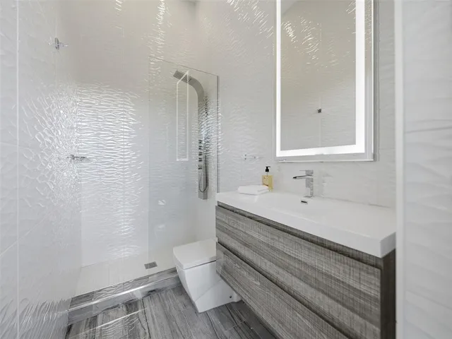 a front view of a house with a yard and palm trees