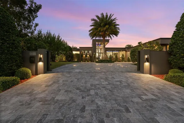 a large kitchen with kitchen island a large window a sink and stainless steel appliances