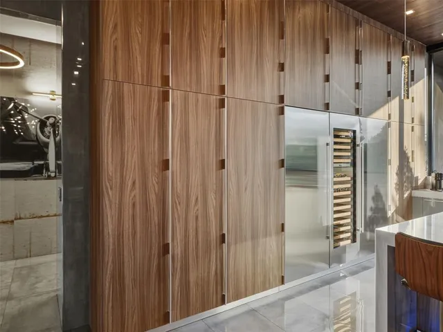 a living room with patio furniture and a large window