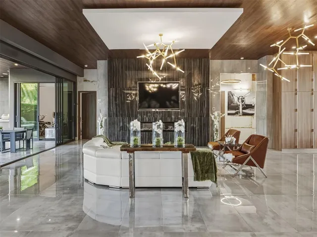 a bathroom with a glass shower door and a wooden floor