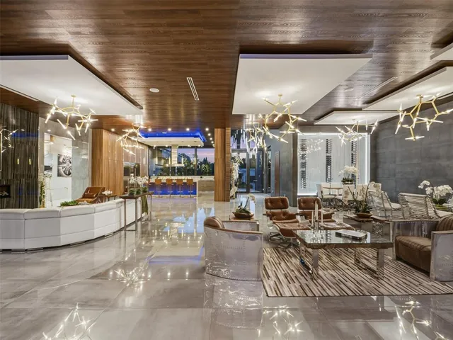 a living room with furniture a fireplace and a large window