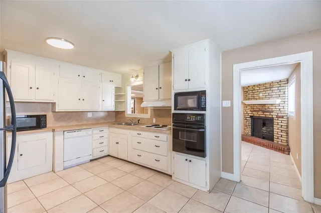 a kitchen with granite countertop cabinets and stainless steel appliances