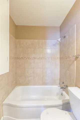 a bathroom with a bathtub and a toilet