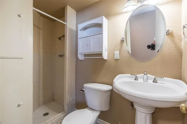 a bathroom with a sink toilet and shower
