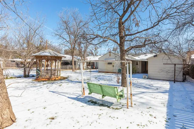 a front view of a house with a tree