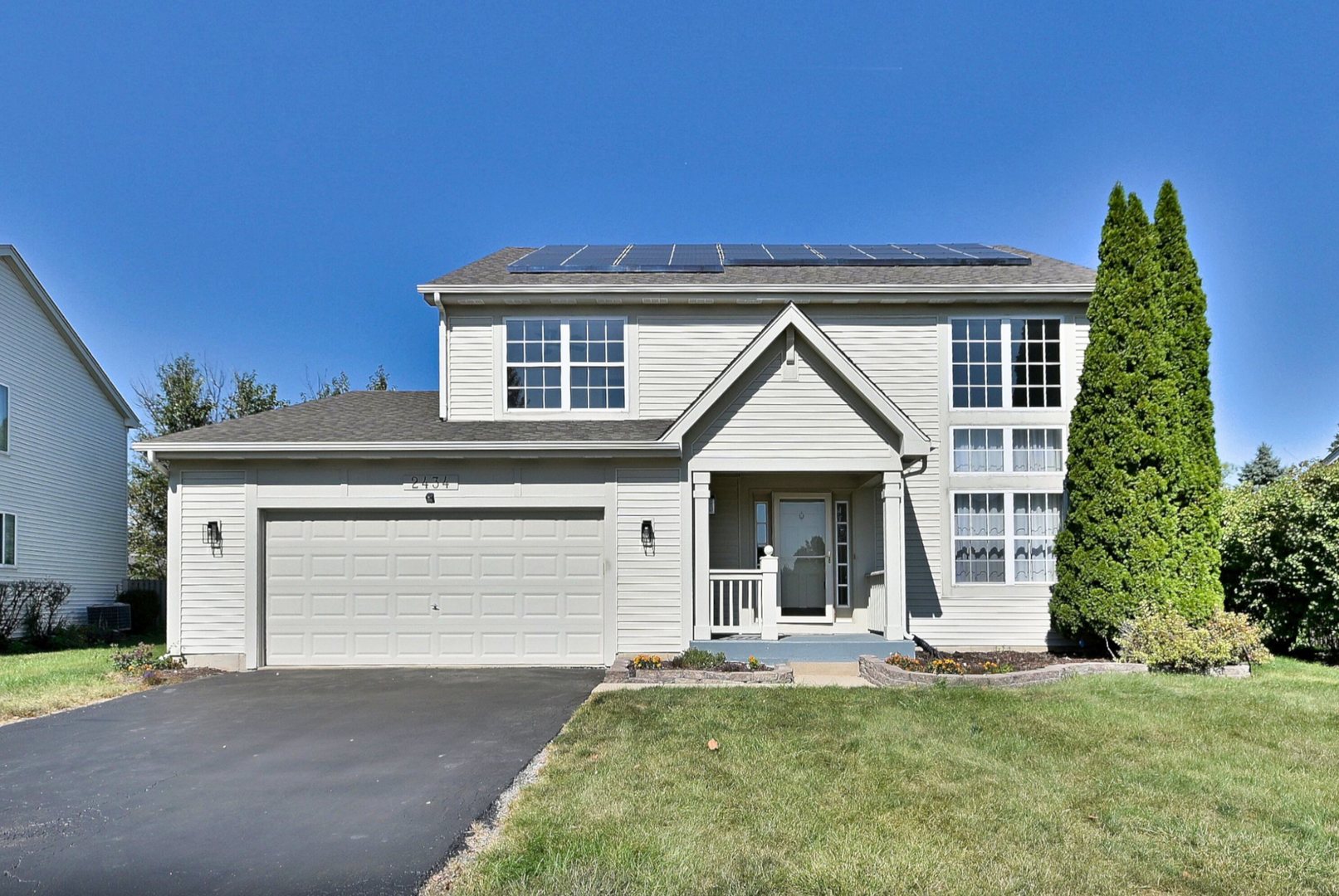a view of a house with a yard and garage