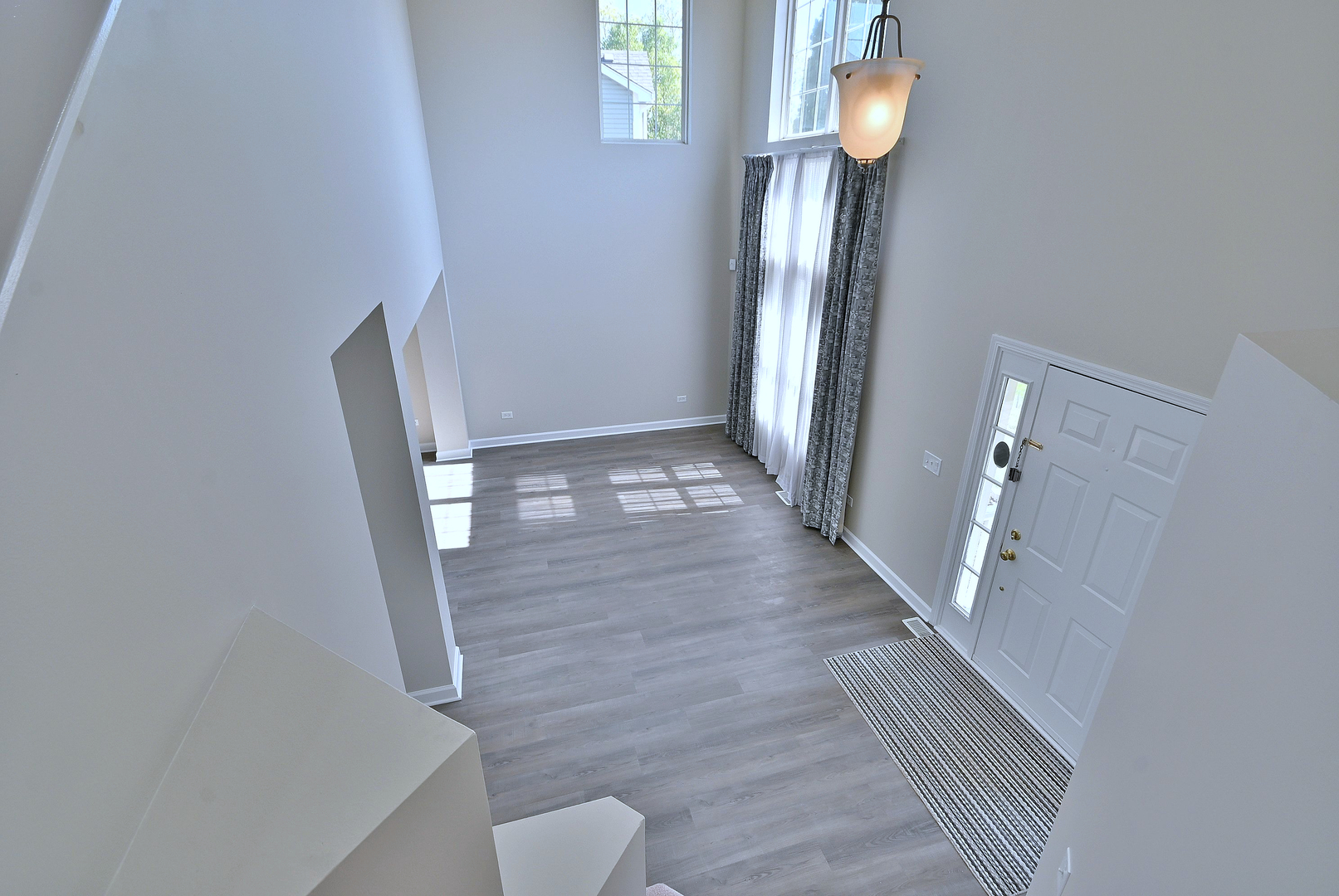 2434 White Barn Road Aurora, IL 60502 - Photo 23 of 45 a view of a hallway with wooden floor and staircase