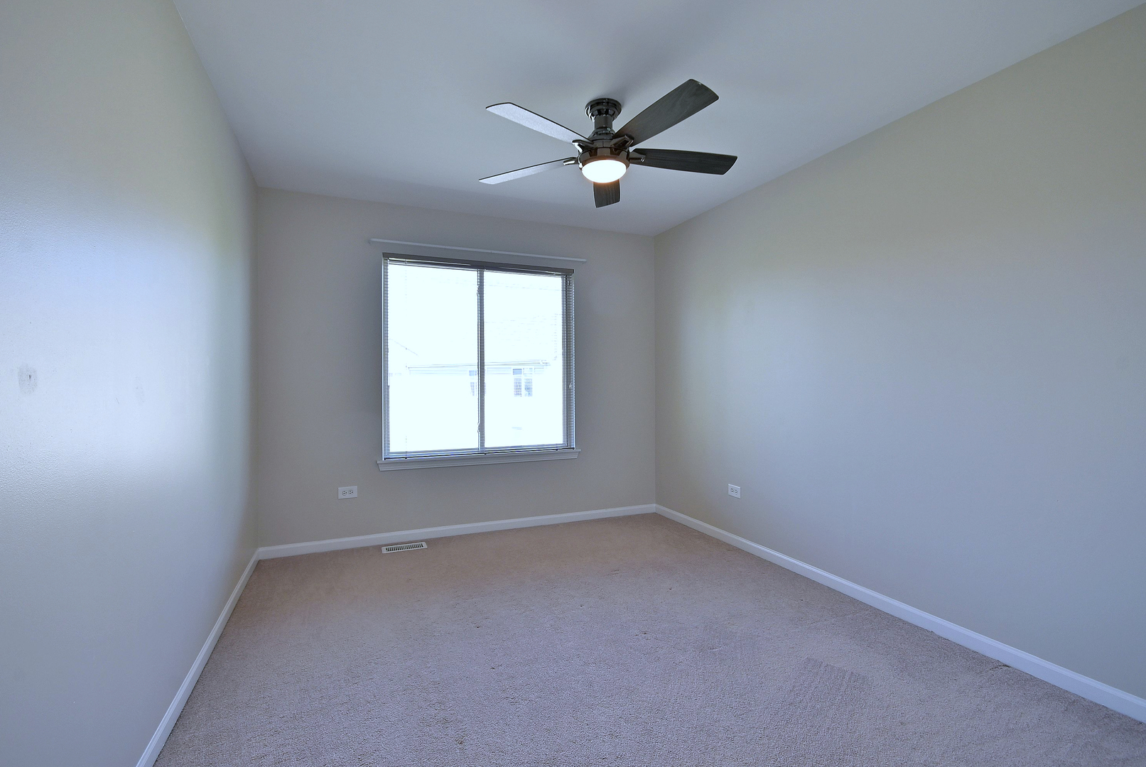 2434 White Barn Road Aurora, IL 60502 - Photo 34 of 45 an empty room with a window and a fan