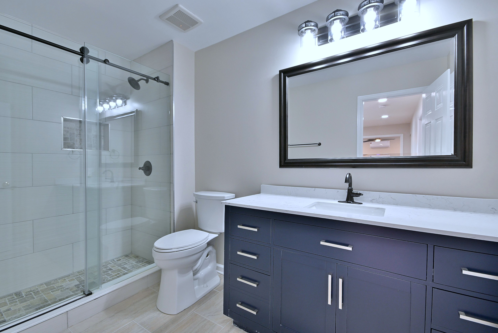 2434 White Barn Road Aurora, IL 60502 - Photo 36 of 45 a bathroom with a toilet a sink a glass door a shower a mirror and vanity