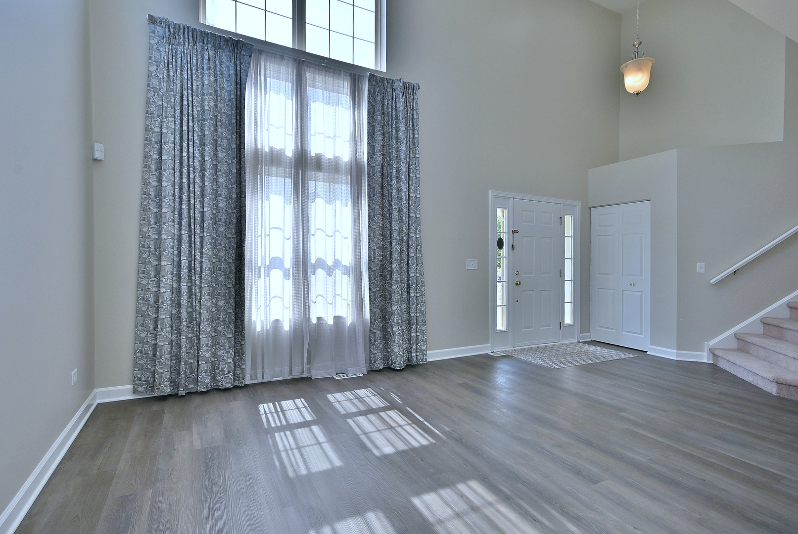 2434 White Barn Road Aurora, IL 60502 - Photo 4 of 45 an empty room with wooden floor and windows