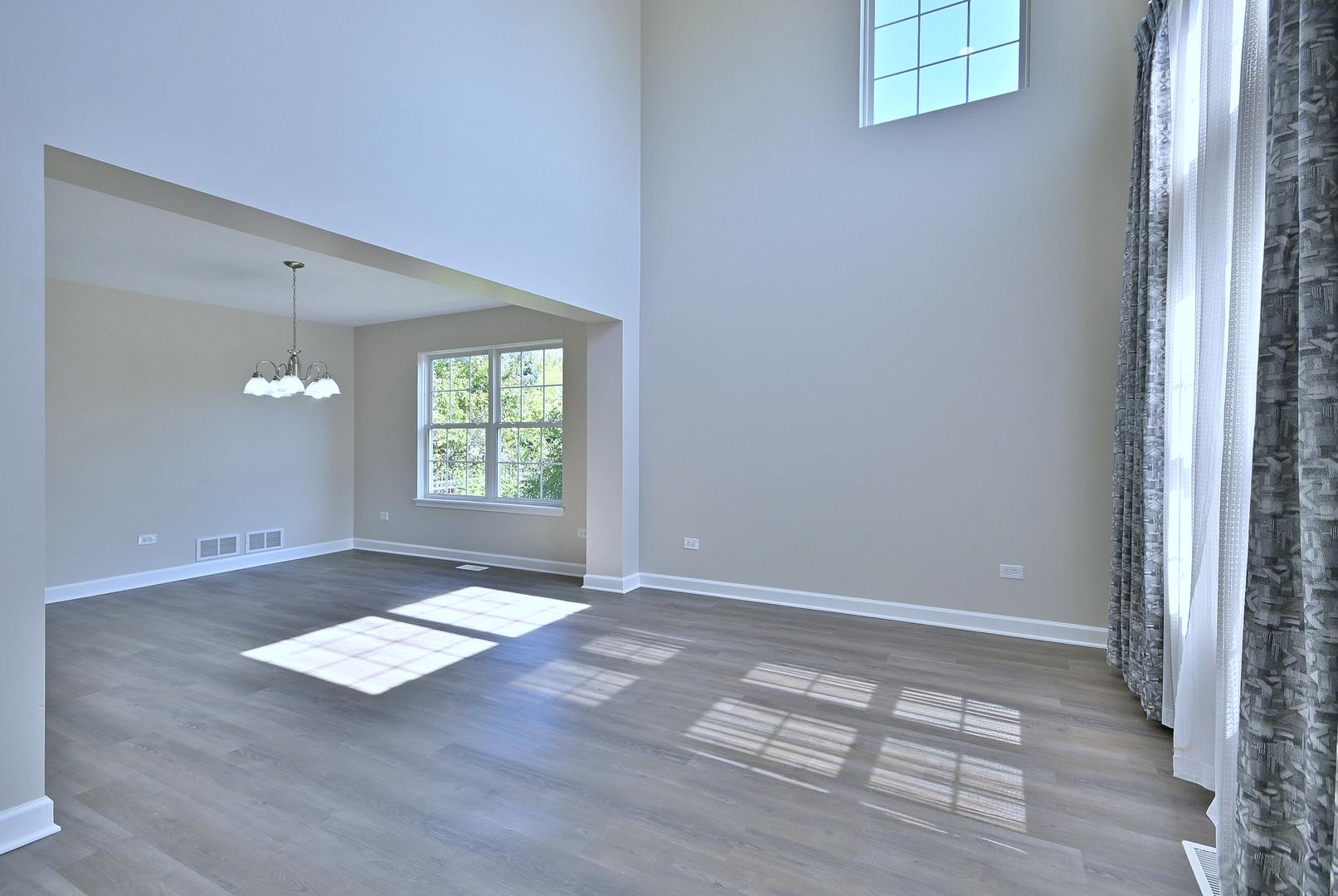 2434 White Barn Road Aurora, IL 60502 - Photo 6 of 45 an empty room with wooden floor and windows