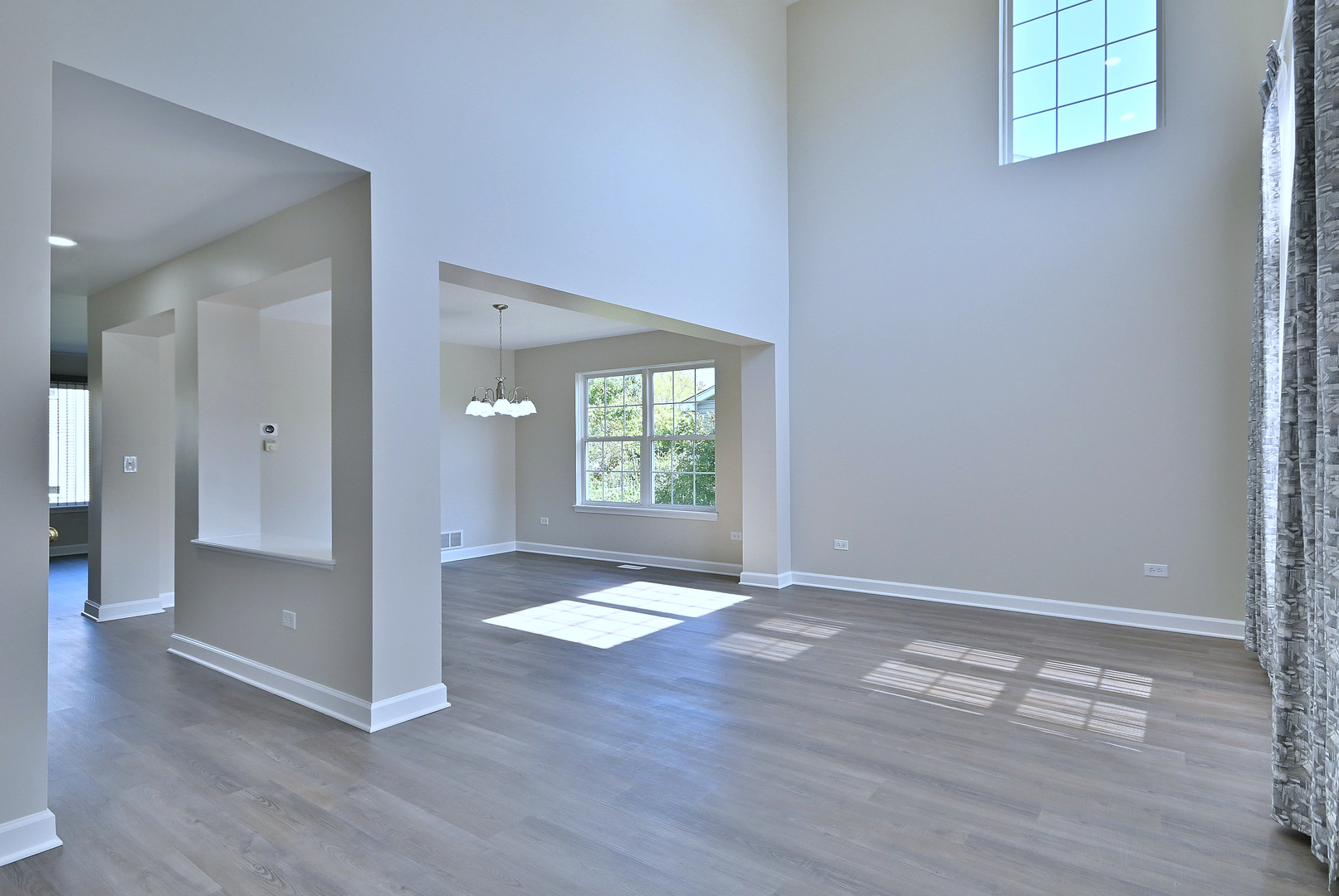 2434 White Barn Road Aurora, IL 60502 - Photo 7 of 45 an empty room with wooden floor cabinet and windows