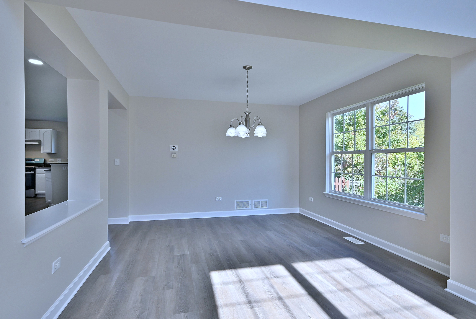 2434 White Barn Road Aurora, IL 60502 - Photo 10 of 45 wooden floor in an empty room with a window