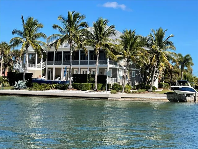 a view of a balcony with furniture and a potted plant