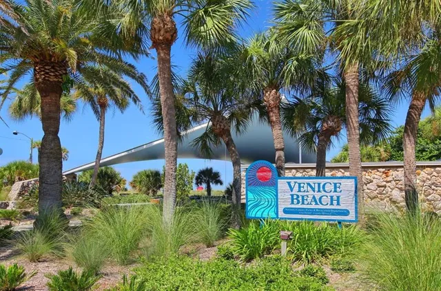 a kitchen with stainless steel appliances granite countertop a sink a stove and a wooden floors