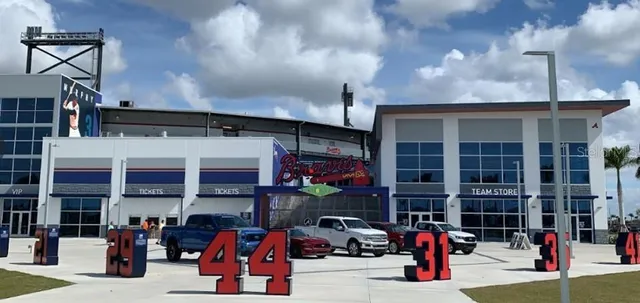 a view of a lake with a big yard and palm trees
