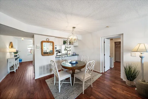 a living room with furniture and chandelier