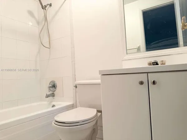 a bathroom with a toilet a sink and bathtub