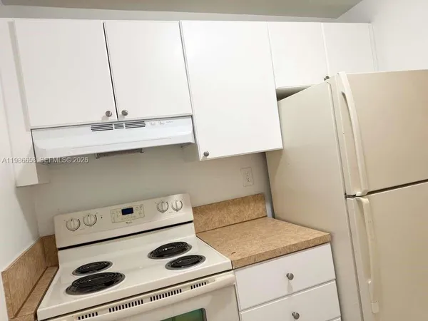 a kitchen with a stove and a refrigerator