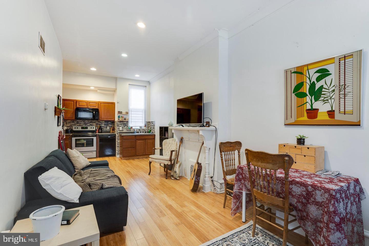 4031 Green Street, Unit A Philadelphia, PA 19104 - Photo 1 of 12 a living room with furniture kitchen view and a flat screen tv