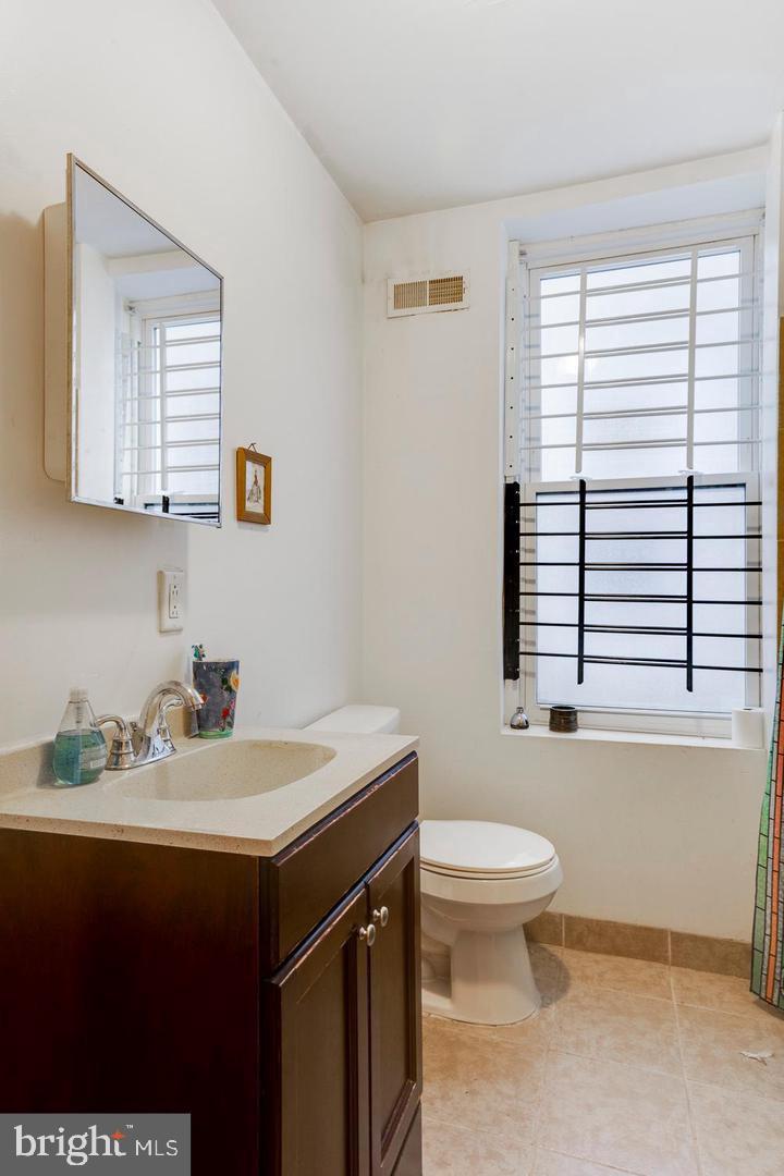 4031 Green Street, Unit A Philadelphia, PA 19104 - Photo 9 of 12 a bathroom with a sink a toilet and a window
