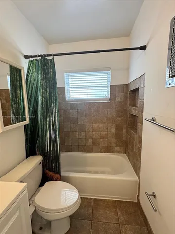 a bathroom with a toilet a sink and bathtub