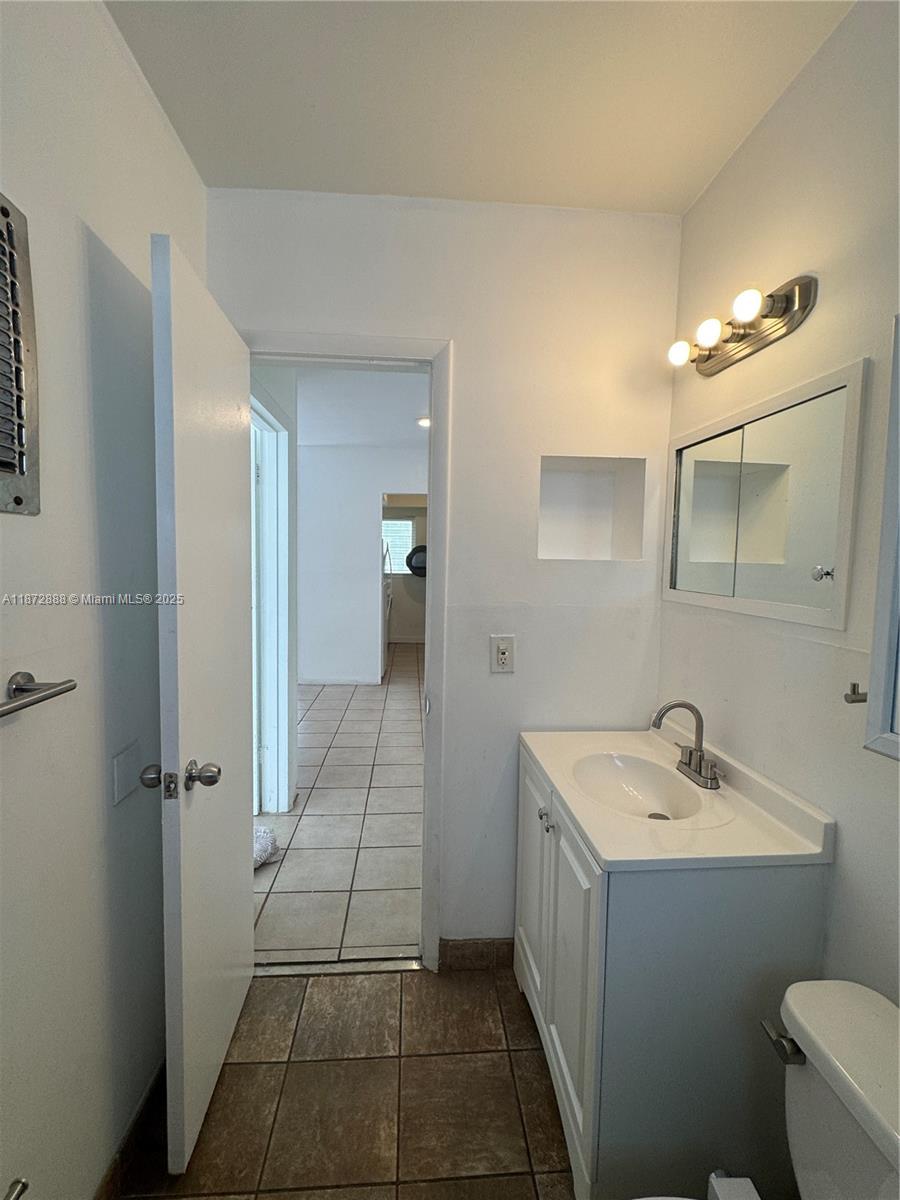 921 Meridian Avenue, Unit 7 Miami Beach, FL 33139 - Photo 25 of 31 a bathroom with a sink and a mirror