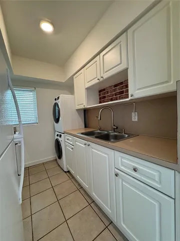a kitchen with a sink a stove and cabinets
